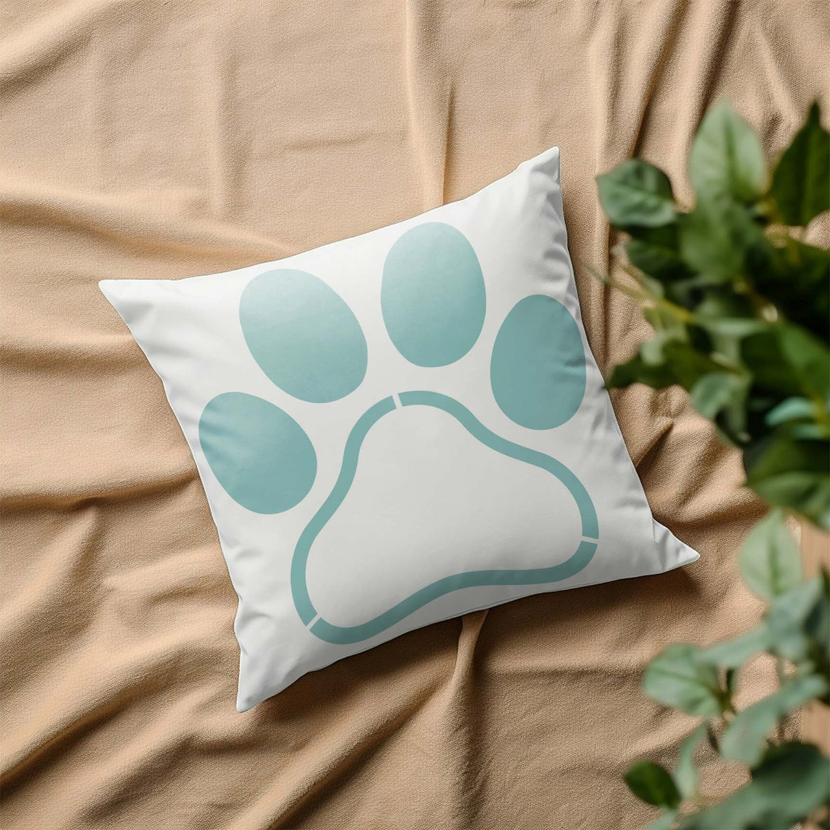 Airy blue Paw Print Frame Stencil decorates a white pillow with a clean outlined paw design