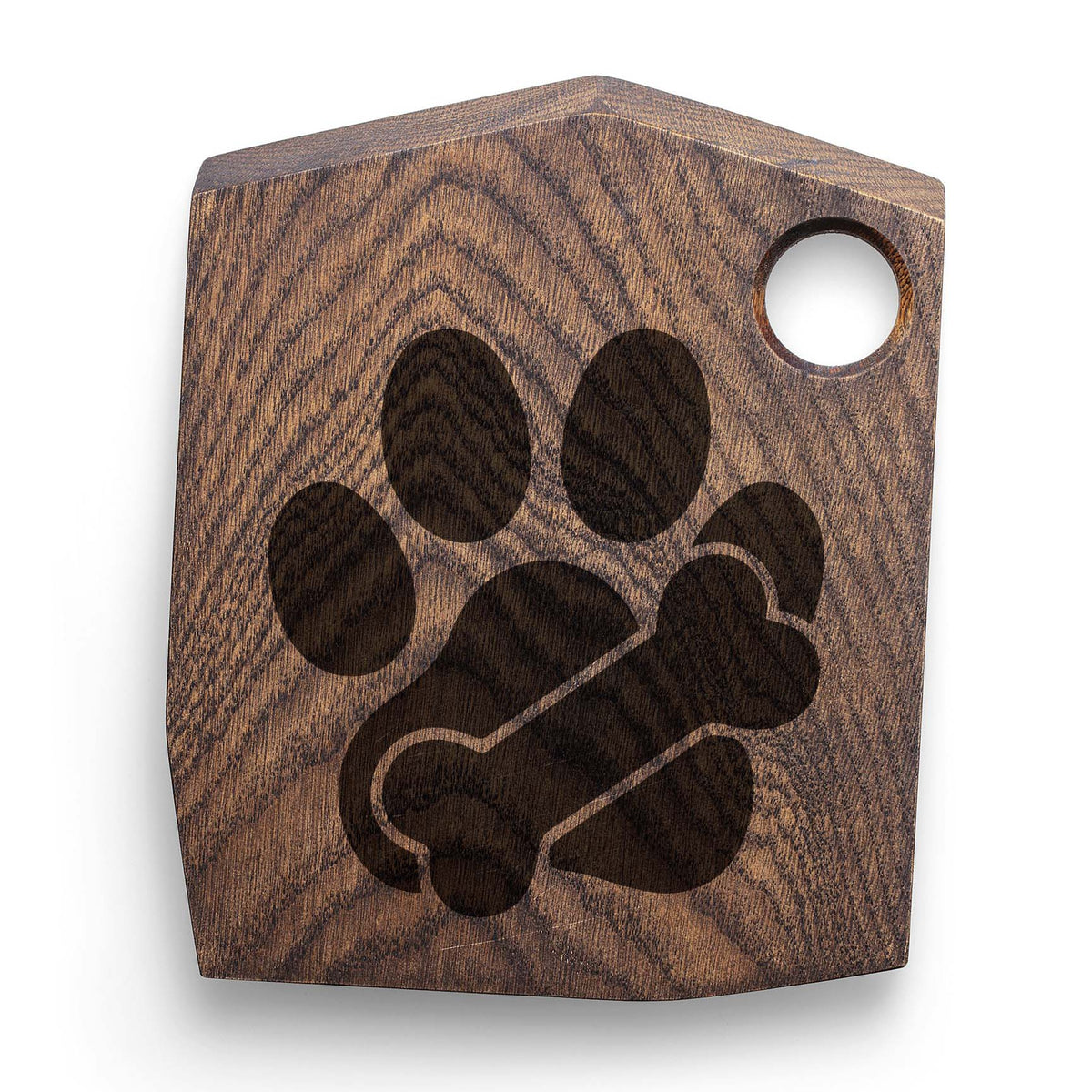 Paw Print with Bone Stencil forms a dark paw and bone design on a rustic wooden cutting board