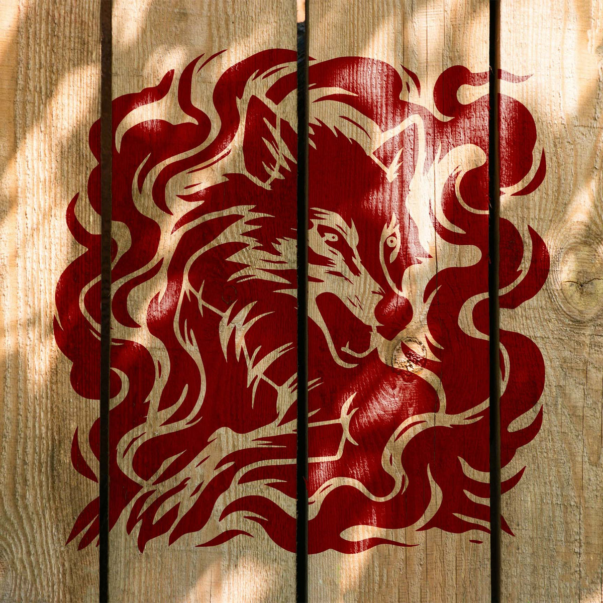Wisps surround the Phantom Wolf Smoke Stencil painted deep red across rustic wooden planks.