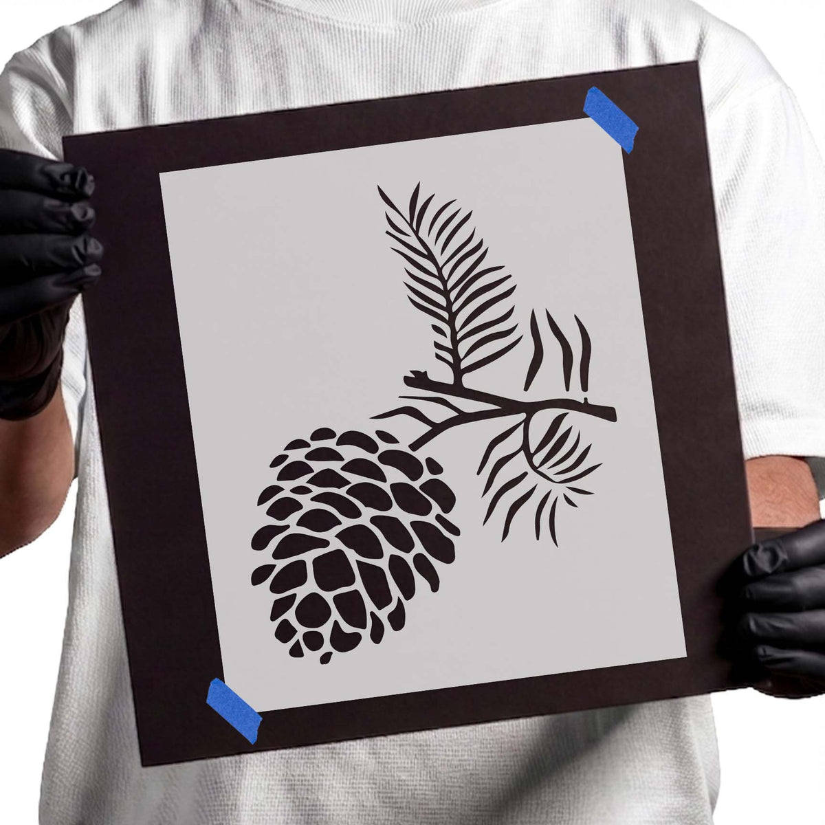 Pine cone stencil with detailed scales, evergreen branch, and slender needles