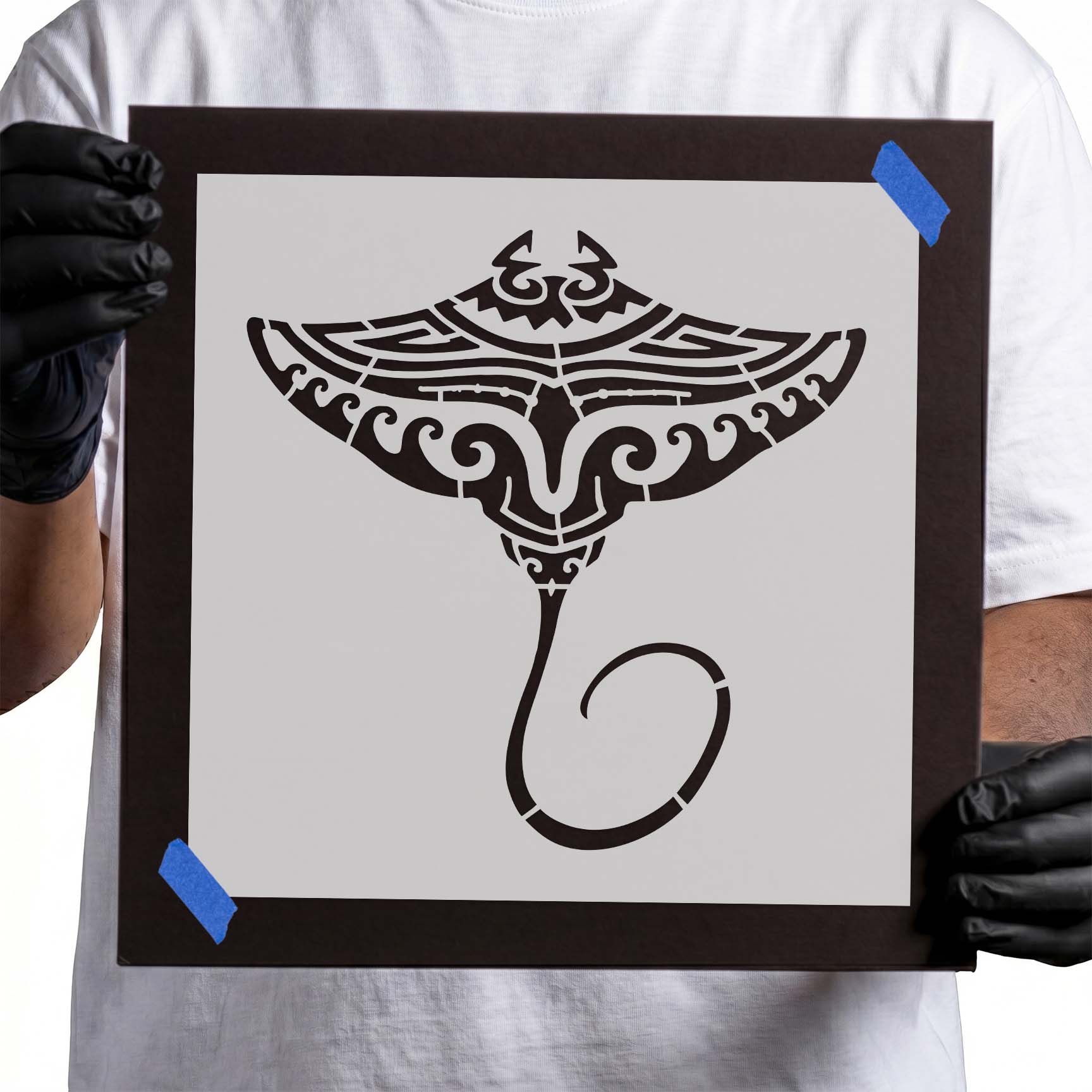 Person holding reusable Polynesian style stingray stencil stop