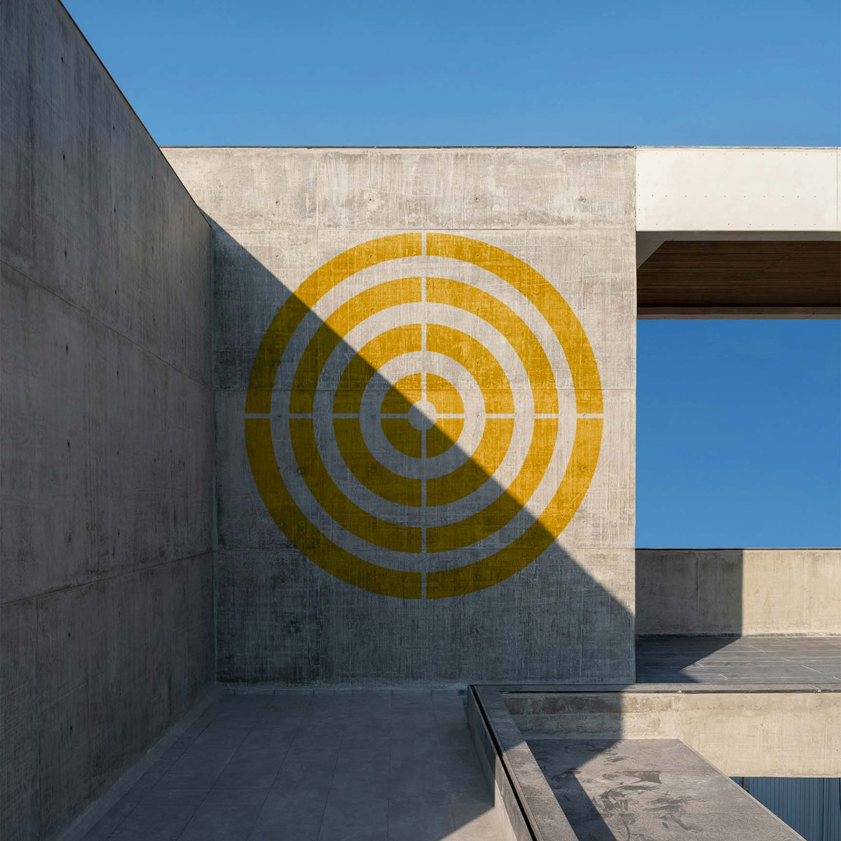Bold yellow Precision Concentric Target Stencil marks a modern concrete wall