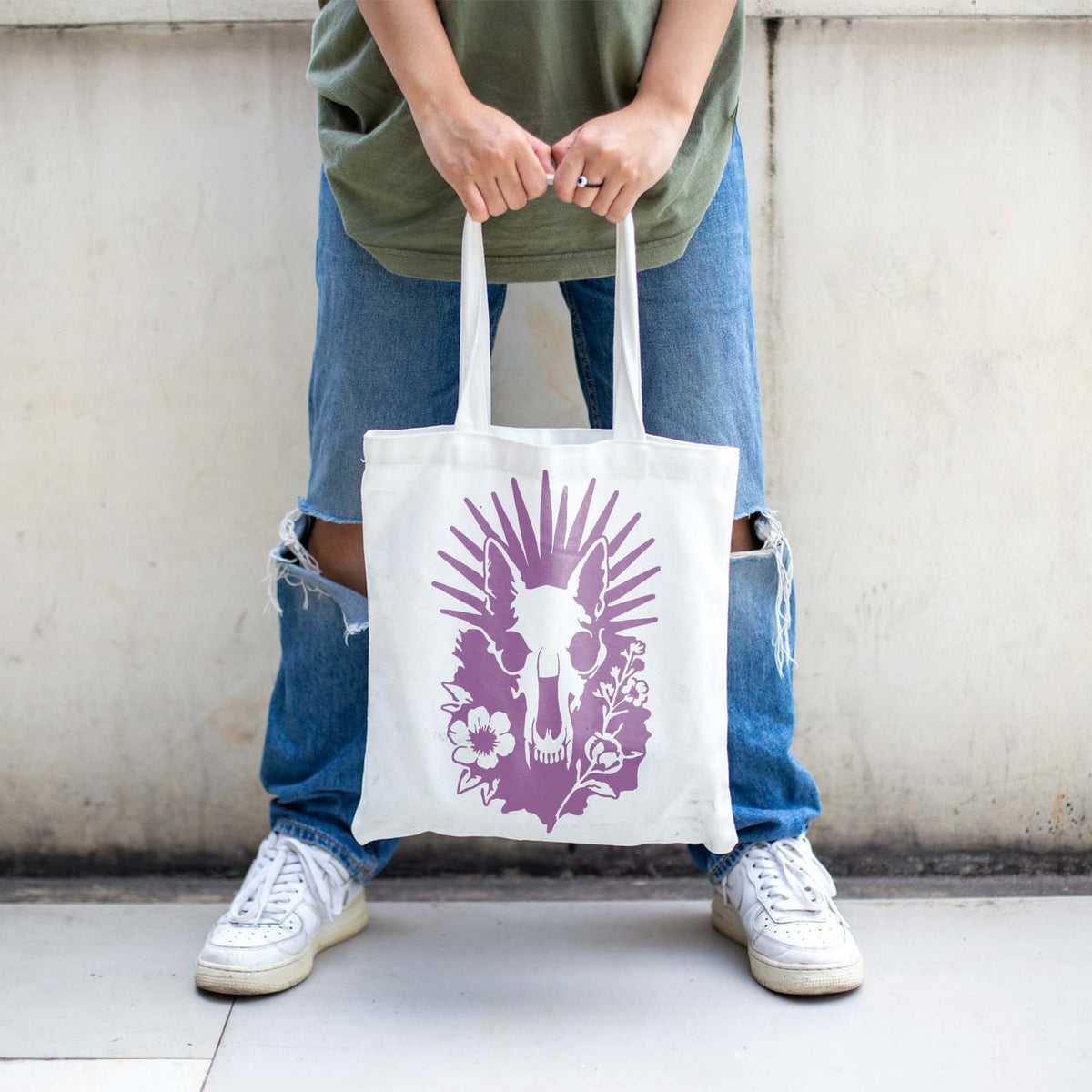 White tote bag displays the Radiant Animal Skull and Wildflower Stencil in soft purple