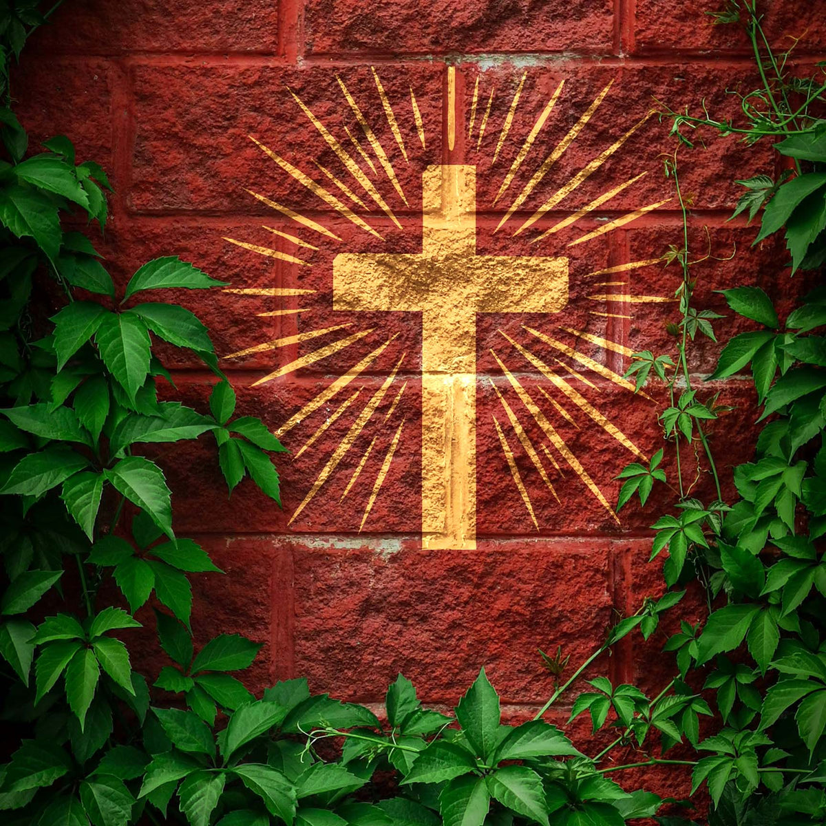 Golden Radiant Cross Stencil shines with dramatic rays across a red brick wall framed by greenery