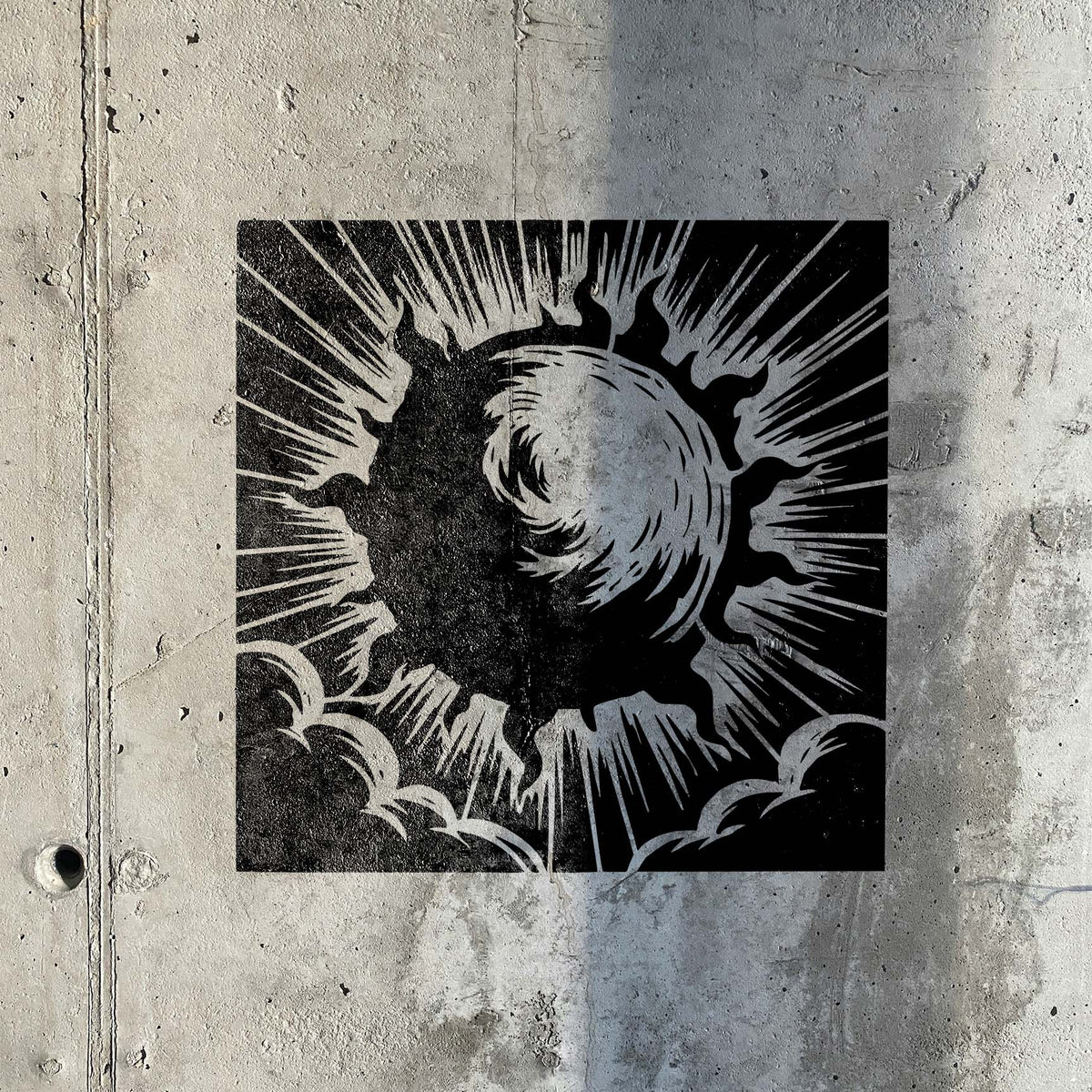 Bold black Radiant Solar Burst Stencil spreads dramatic sun rays across a concrete wall