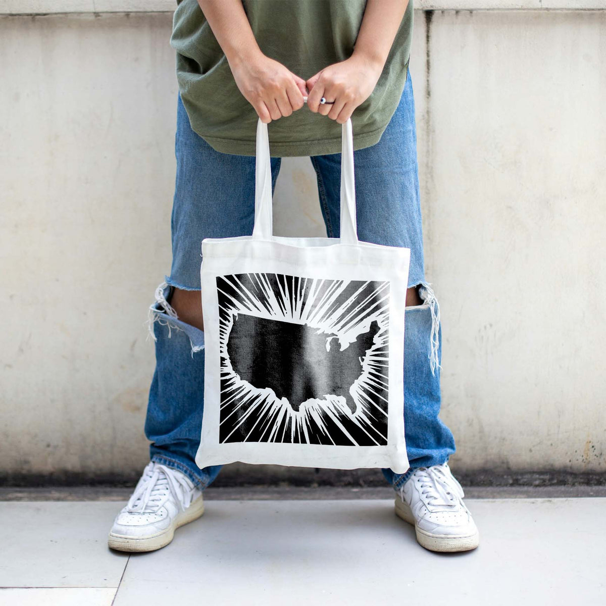 Radiant USA Map Stencil printed in black across a white tote bag with dramatic sunburst rays