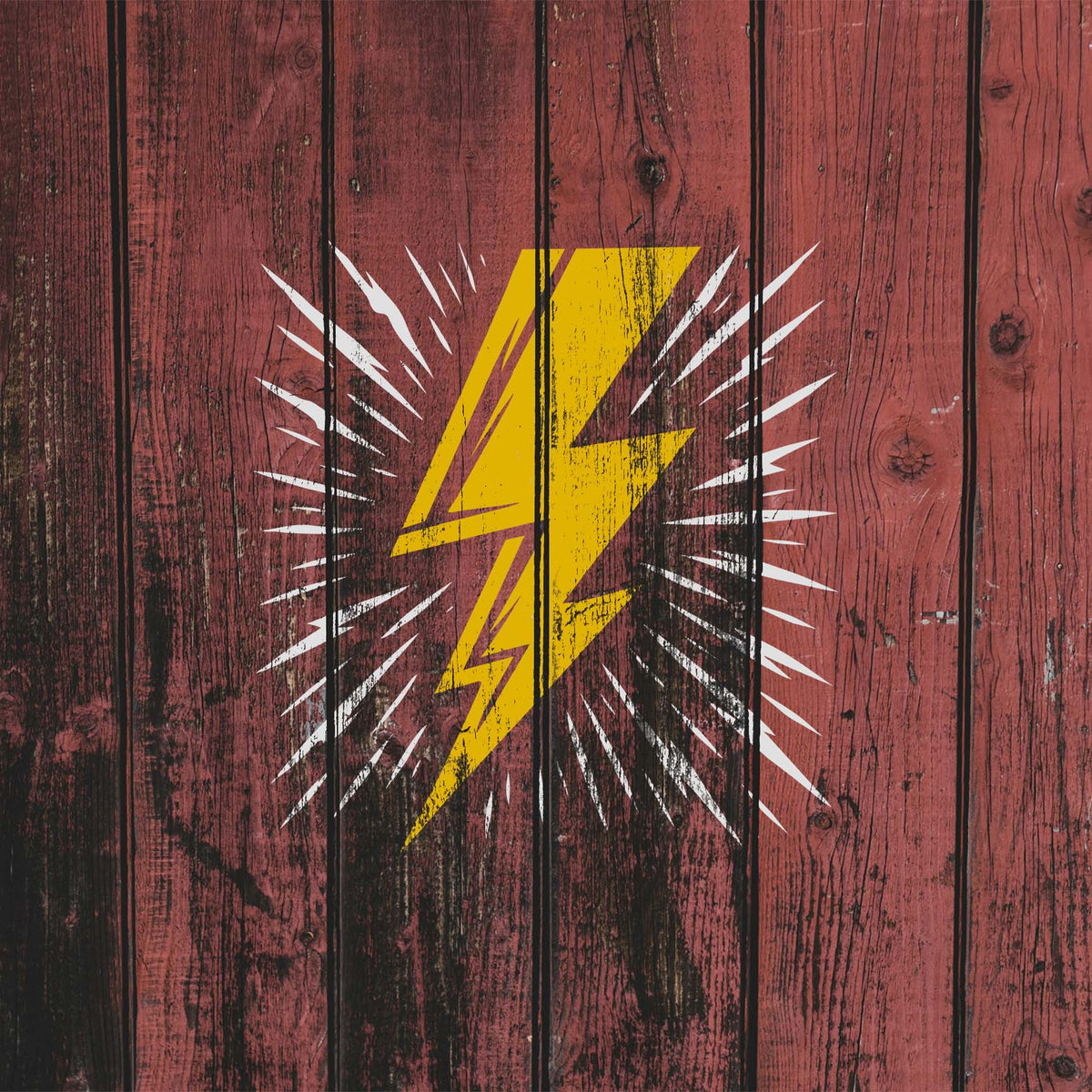 Weathered wood showcases the Radiating Lightning Bolt Stencil with a bold yellow bolt and white rays