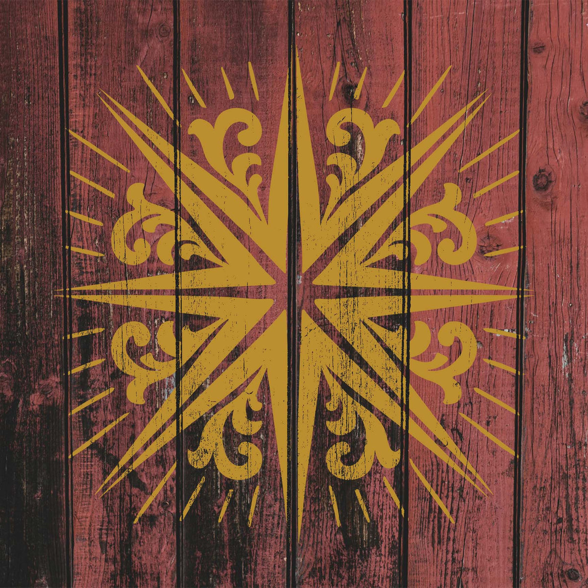 Rustic red wood showcases the Radiating Scroll Star Stencil in gold with sweeping rays