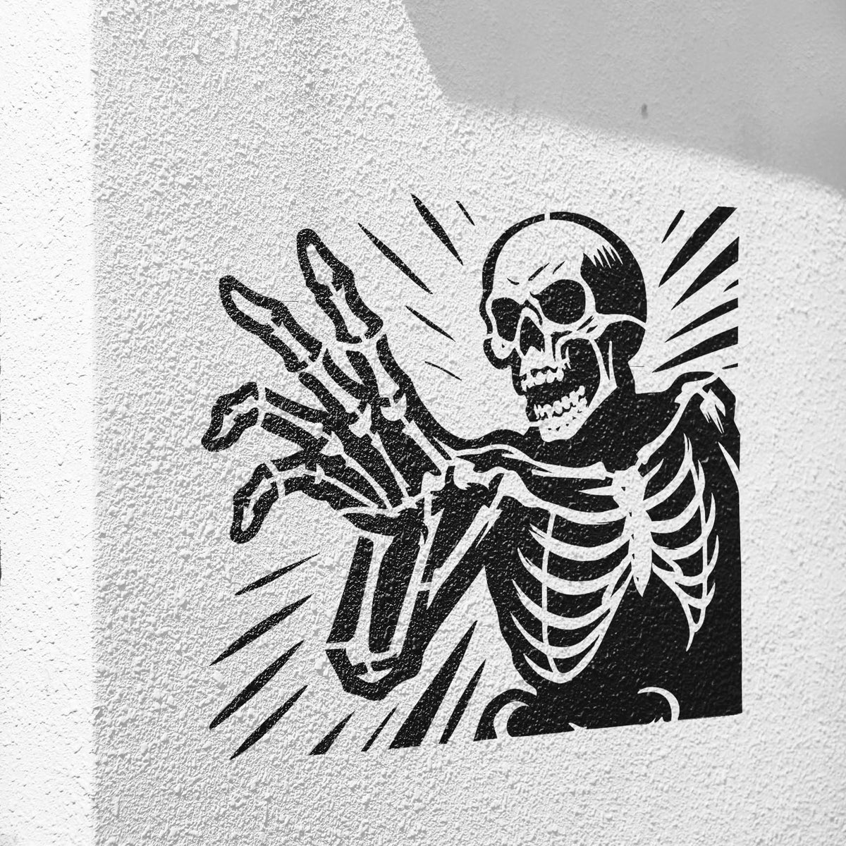 Black Reaching Skeleton Halloween Stencil emerges dramatically across a textured white wall