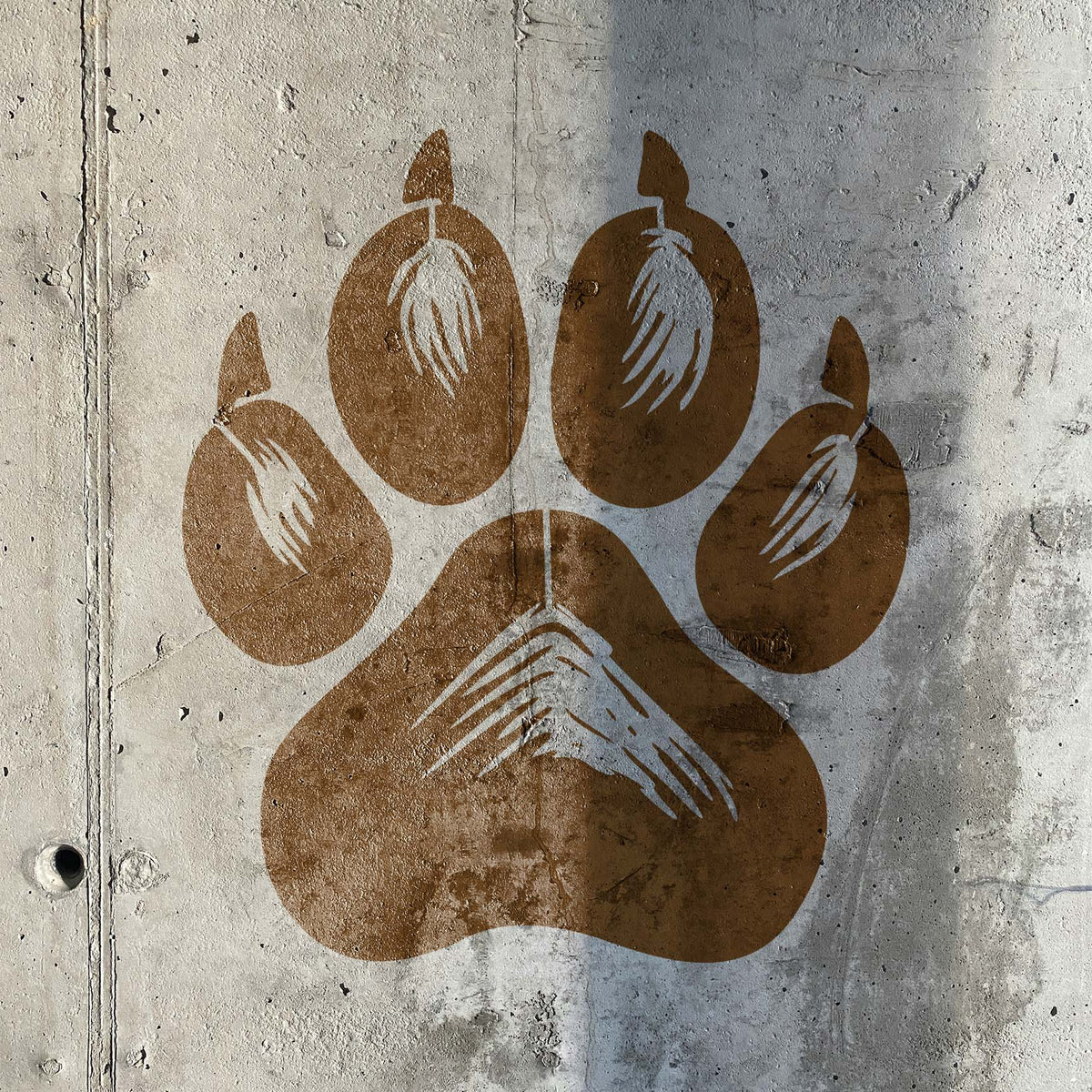 Realistic Dog Paw Print Stencil with detailed claw marks painted on concrete