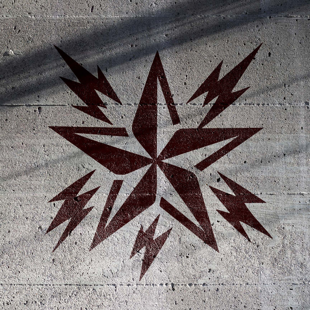 Rockstar Lightning Star Stencil strikes across concrete with bold star and electric bolt details