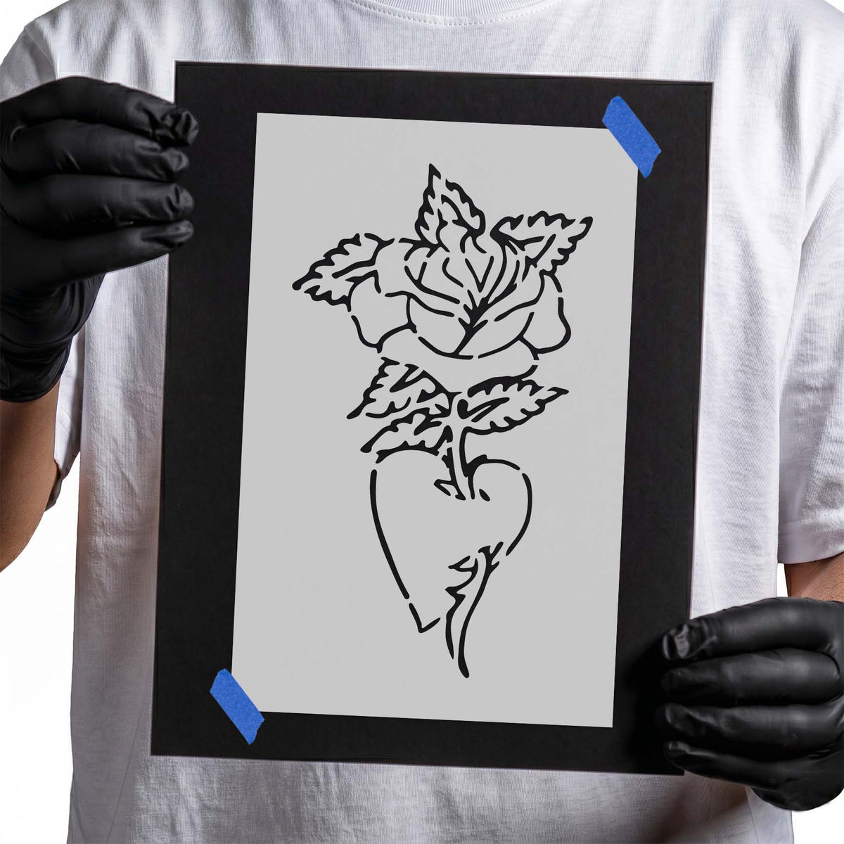 Floral stencil showing a blooming rose with serrated leaves rising from a heart-shaped vase