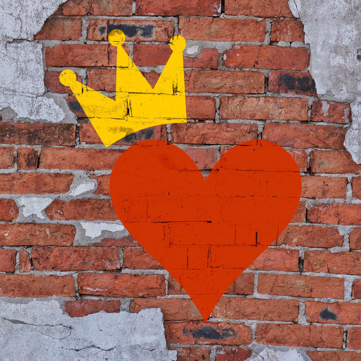 Royal Heart Stencil paints a vivid crowned heart across a weathered exposed brick wall