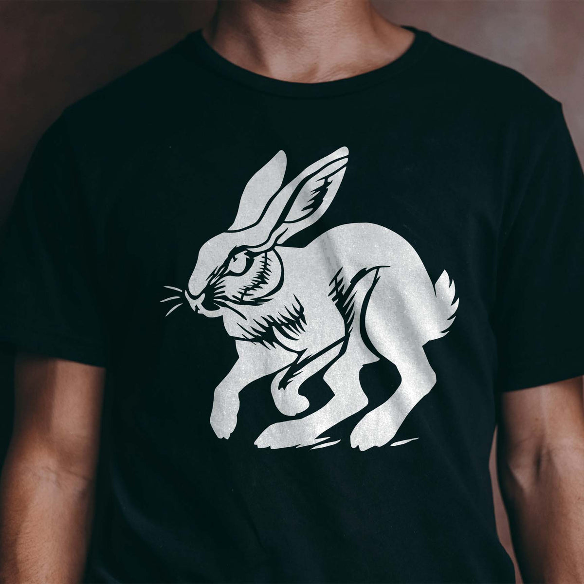 Running jackrabbit stencil with detailed ears printed on a black shirt