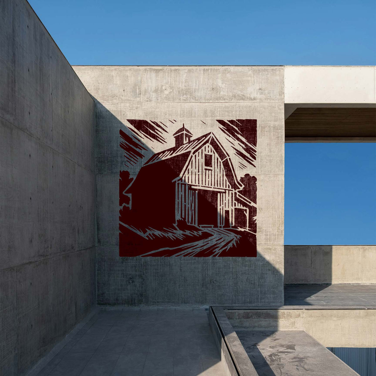 Rustic Gambrel Barn Stencil displayed in deep red on a modern concrete courtyard wall.