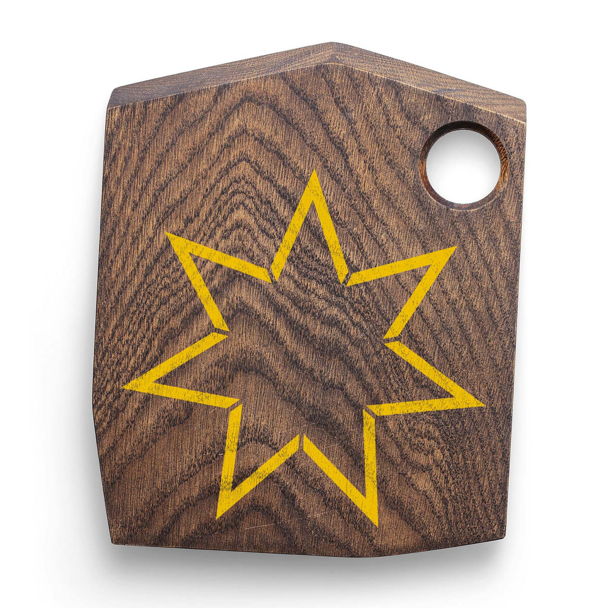A wooden cutting board features the Seven Point Star Outline Stencil in a bright yellow finish