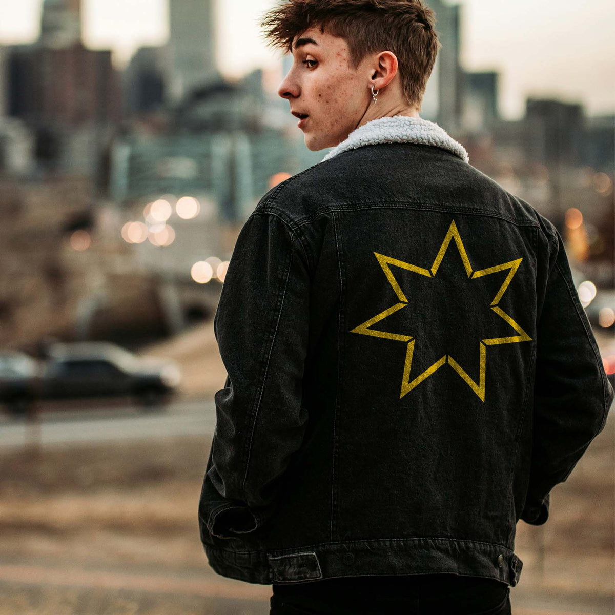 Seven Point Star Outline Stencil adds a bold gold geometric design to the back of a black denim jacket