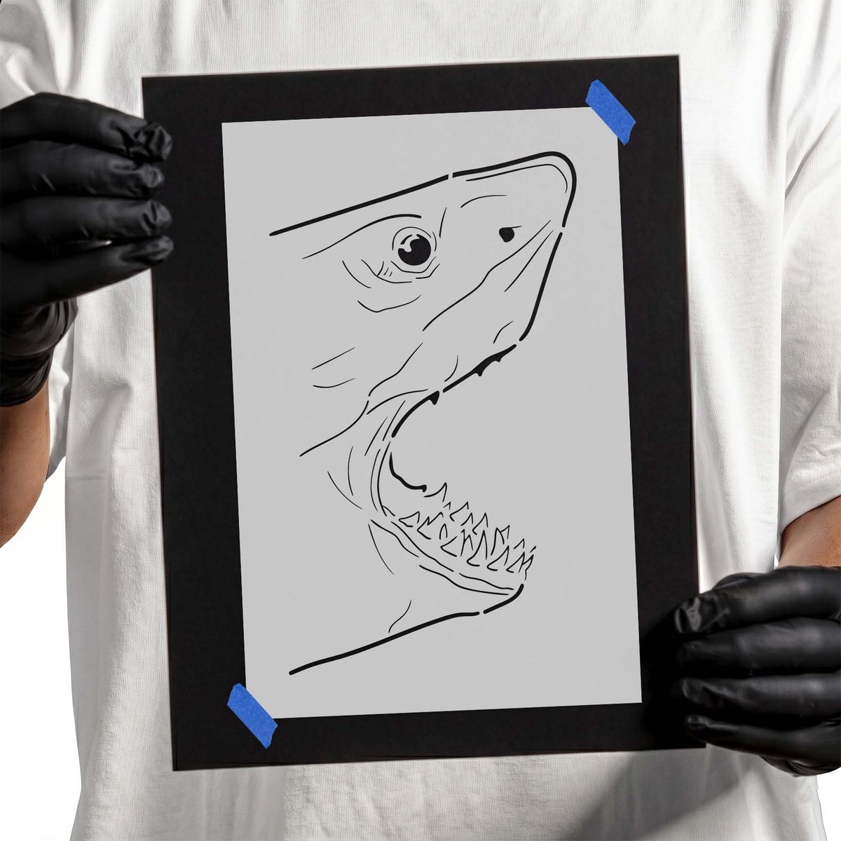 Open-jawed shark face stencil with sharp teeth and detailed eye