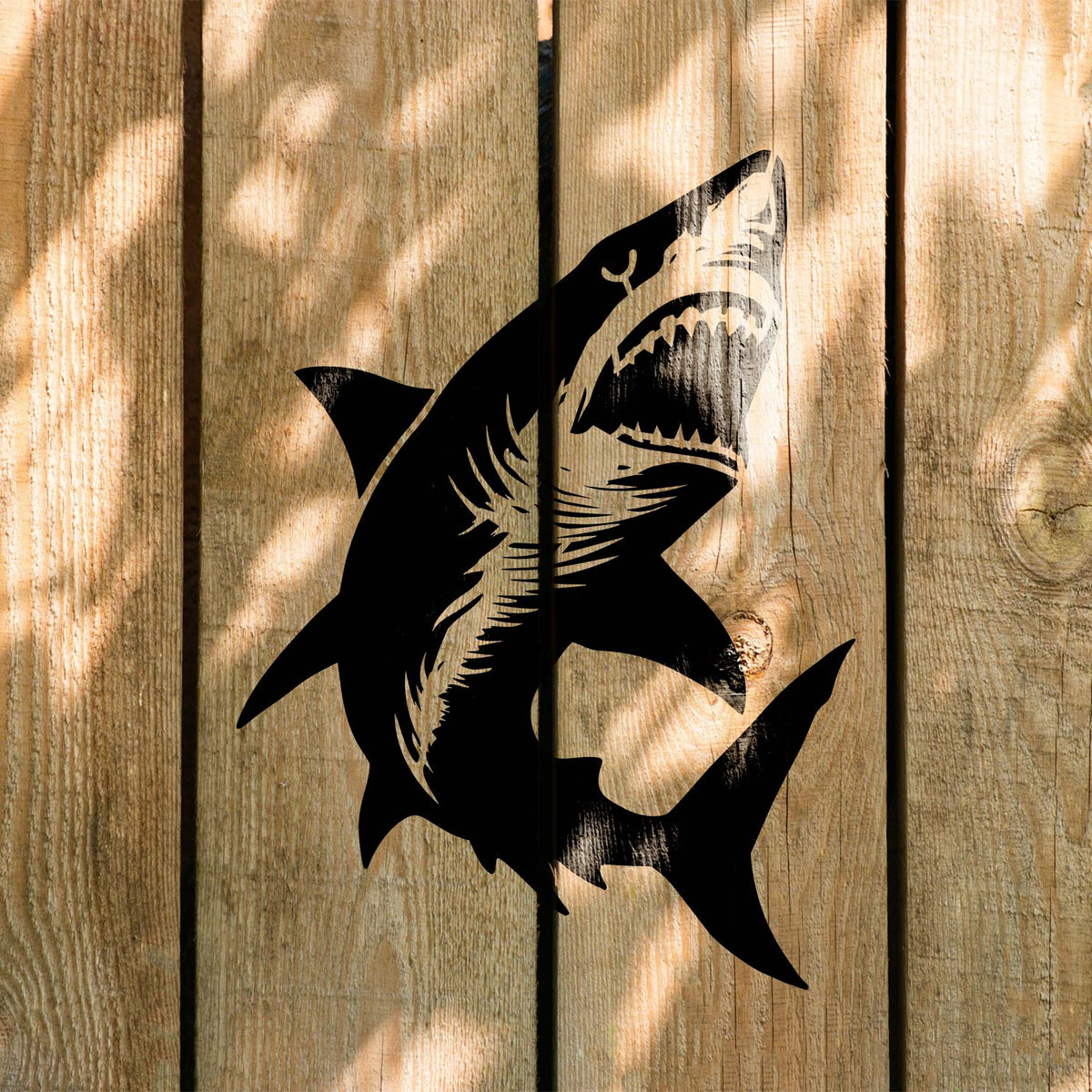 Shark Swimming Up Stencil displays its open-jaw design across sunlit wooden boards