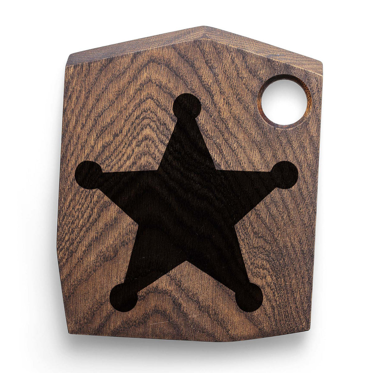 A rustic wood cutting board displays the Sheriff Star Stencil in a classic black finish