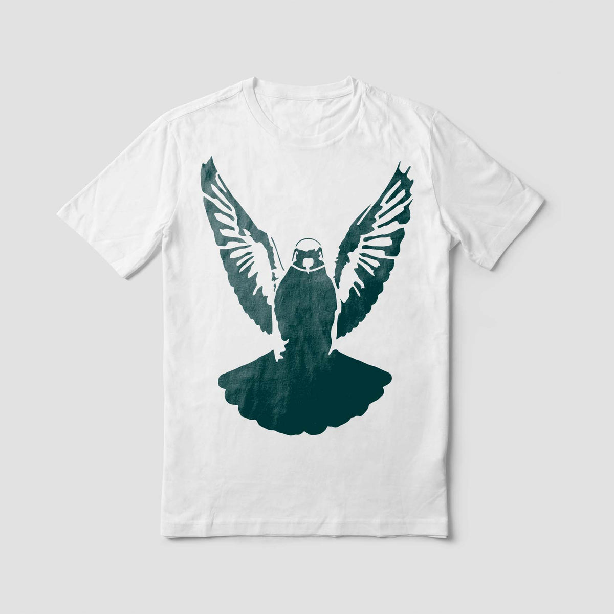 A dark teal Soaring Pigeon Stencil spreads its feathered wings across the front of a white T-shirt.