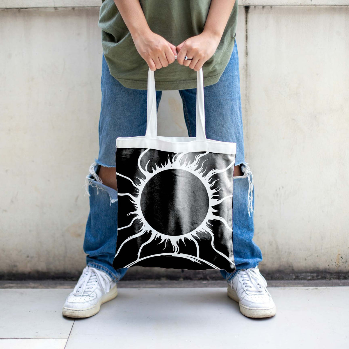 A Solar Eclipse Horizon Stencil makes a dramatic black celestial print on a white tote bag