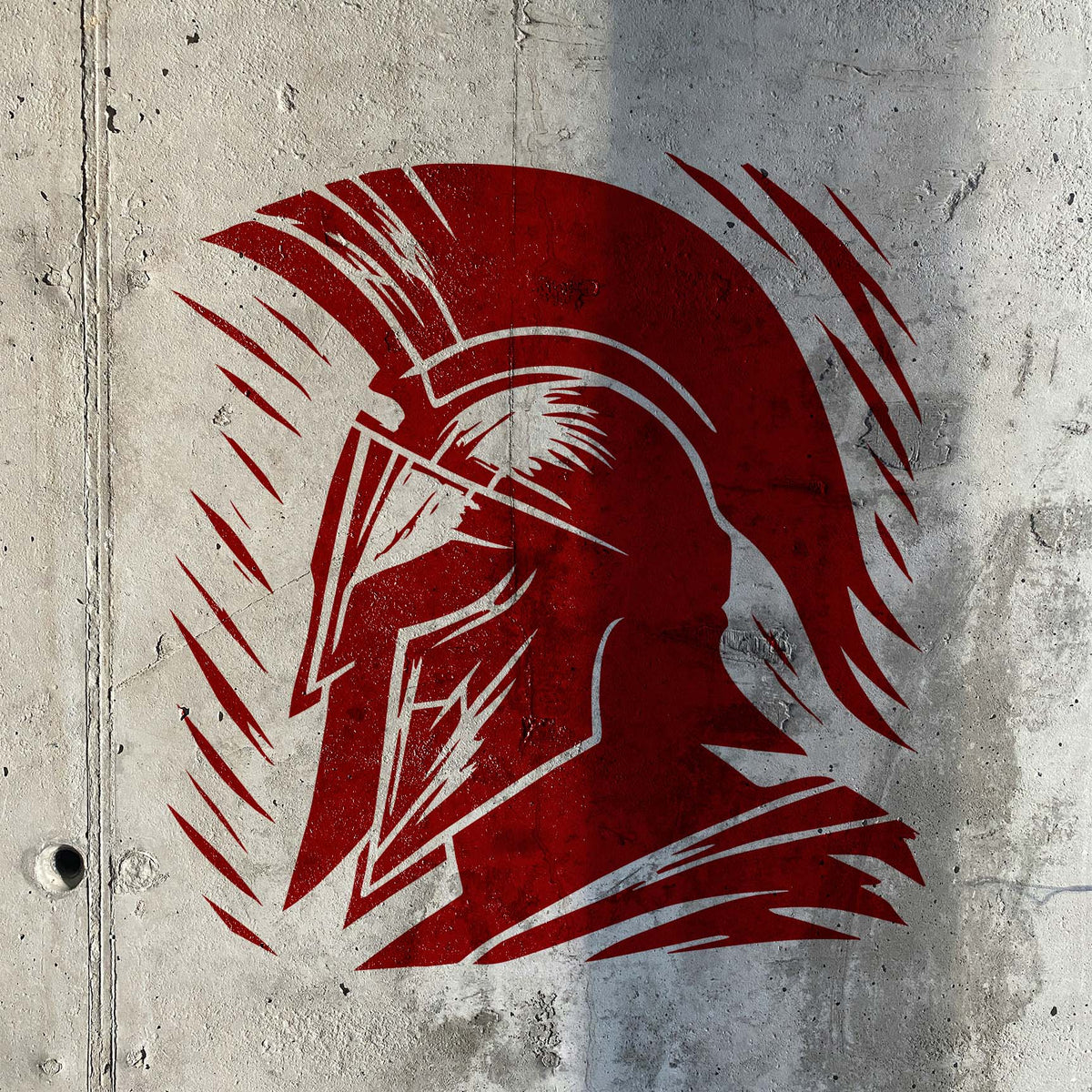 Ancient Spartan Warrior Helmet Stencil painted red on a textured concrete wall.