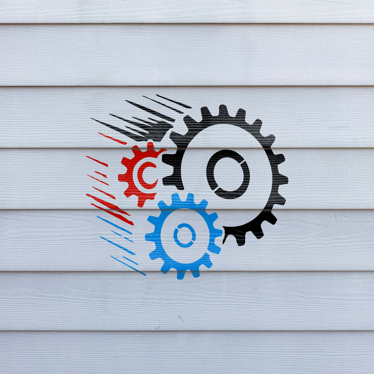 Speeding Gears stencil with black, red, and blue cogwheels and dynamic motion lines on white siding