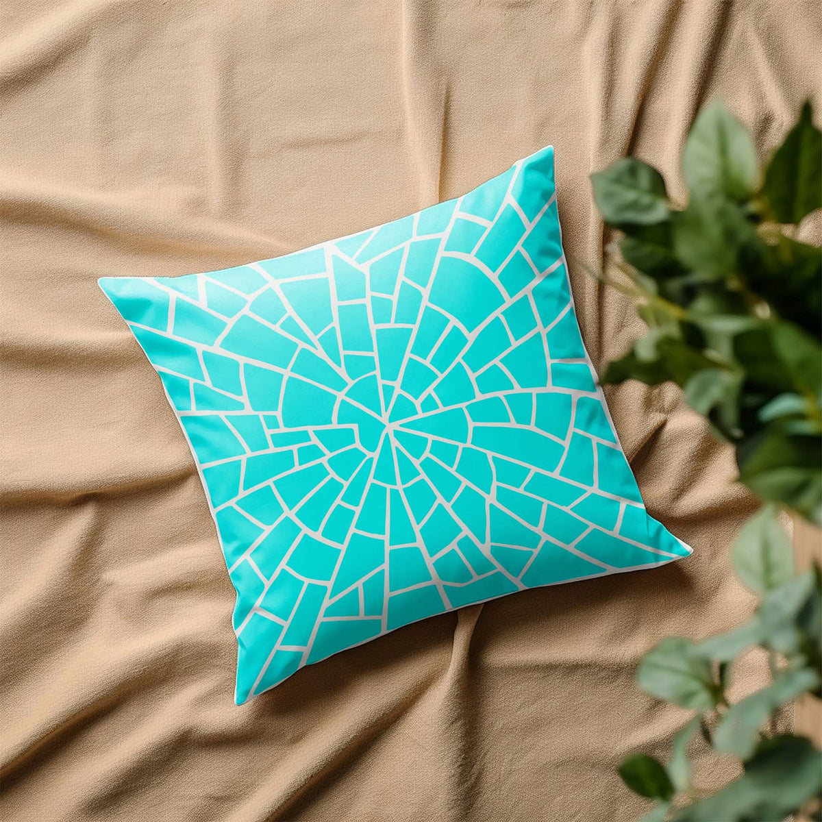 Spiral Stone Mosaic Pattern Stencil forms a turquoise fractured spiral across a decorative pillow