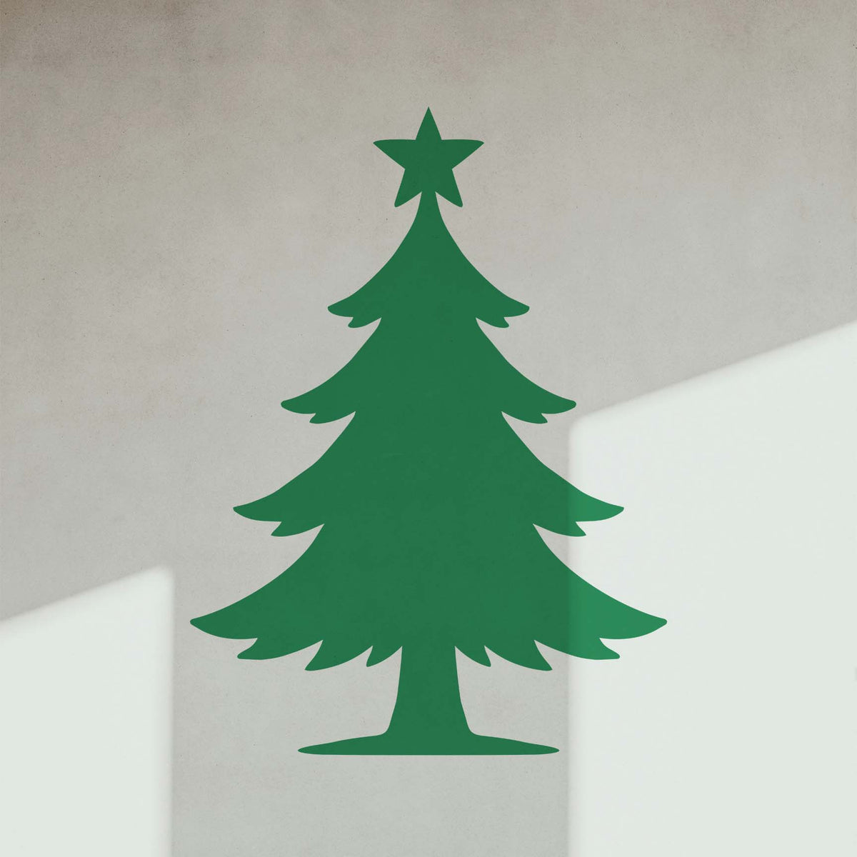 Star Topped Christmas Tree Stencil shown in green on a light interior wall.
