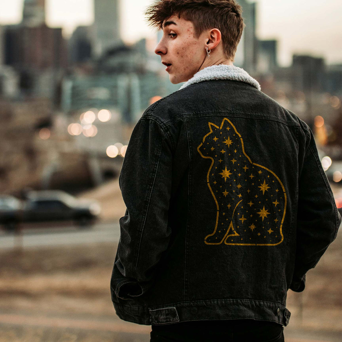 Golden Starry Cat Silhouette Stencil adds a celestial cat design to the back of a denim jacket