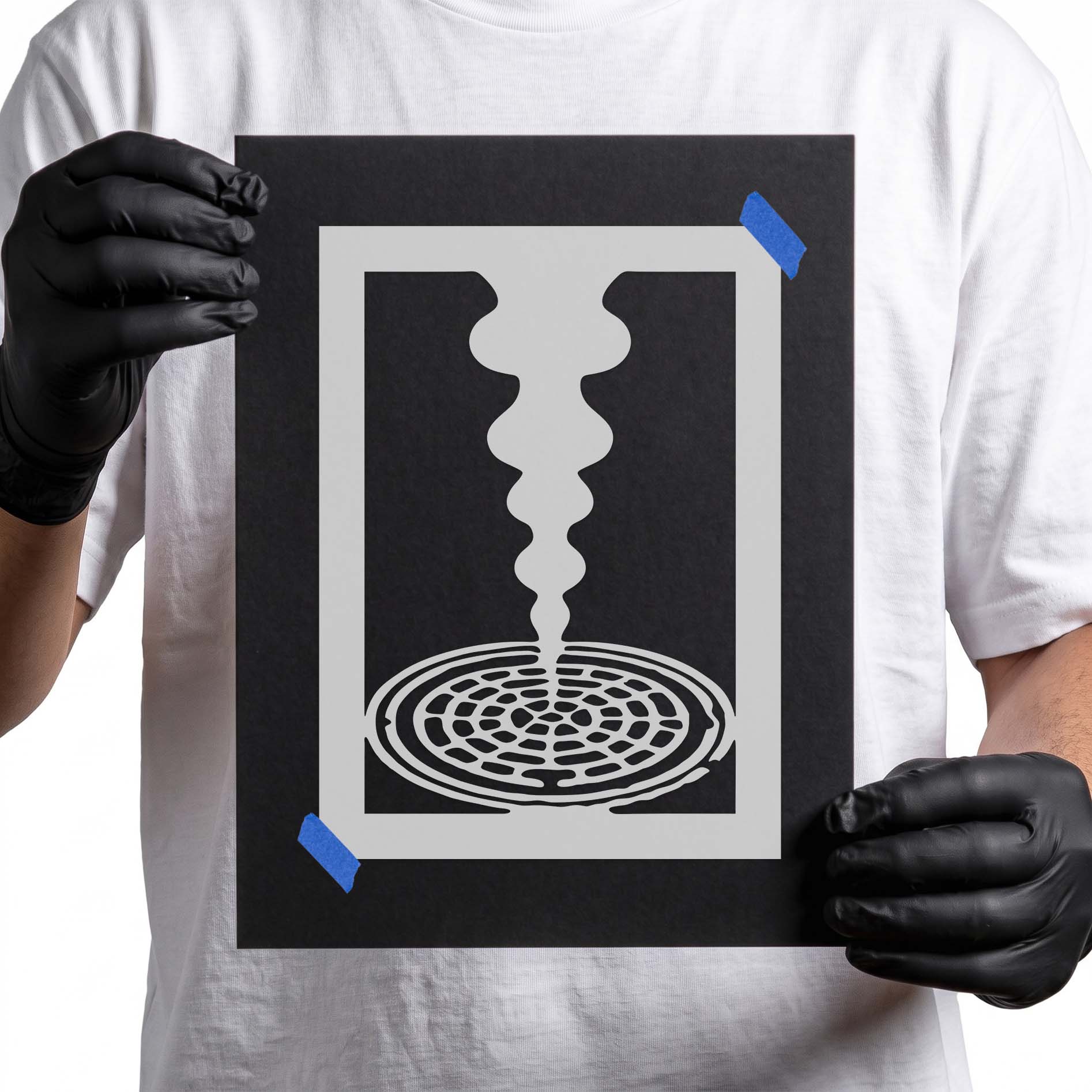 Person holding Steaming Manhole Stencil taped to black cardboard
