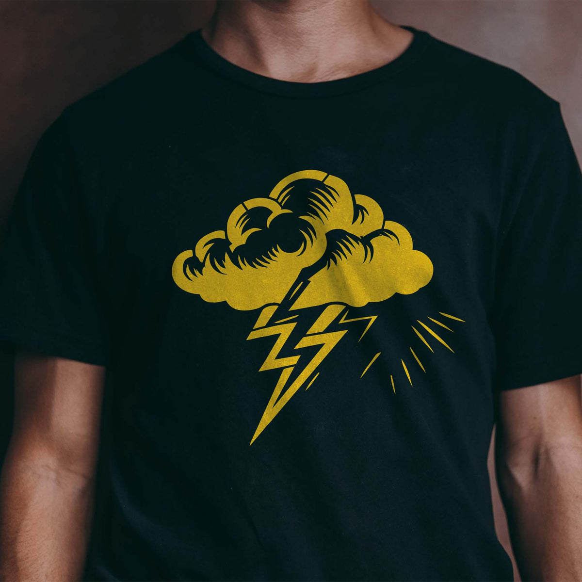Storm Cloud Lightning Bolt Stencil with bold yellow thundercloud and striking bolts on black shirt