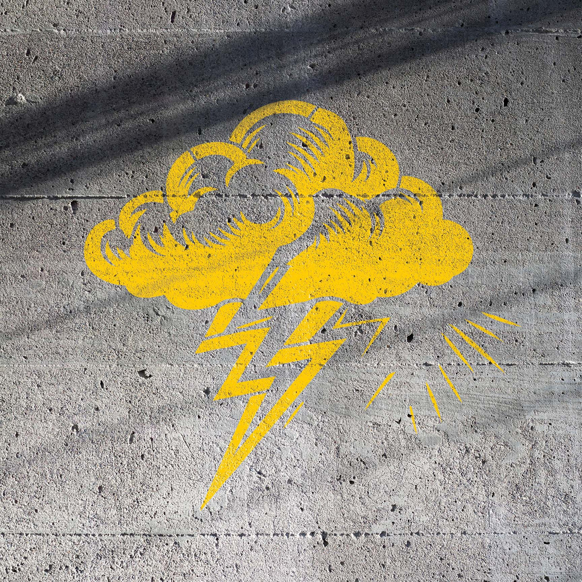 Yellow Storm Cloud Lightning Bolt Stencil painted across a textured concrete wall