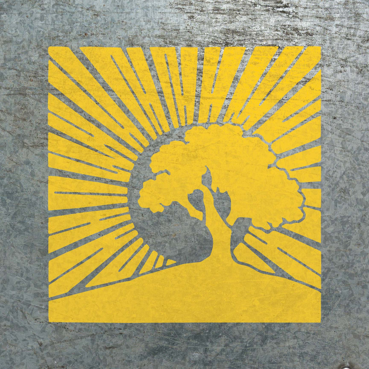 Bold yellow sunrays frame the Sunrise Tree Silhouette Stencil painted across a textured metal surface.