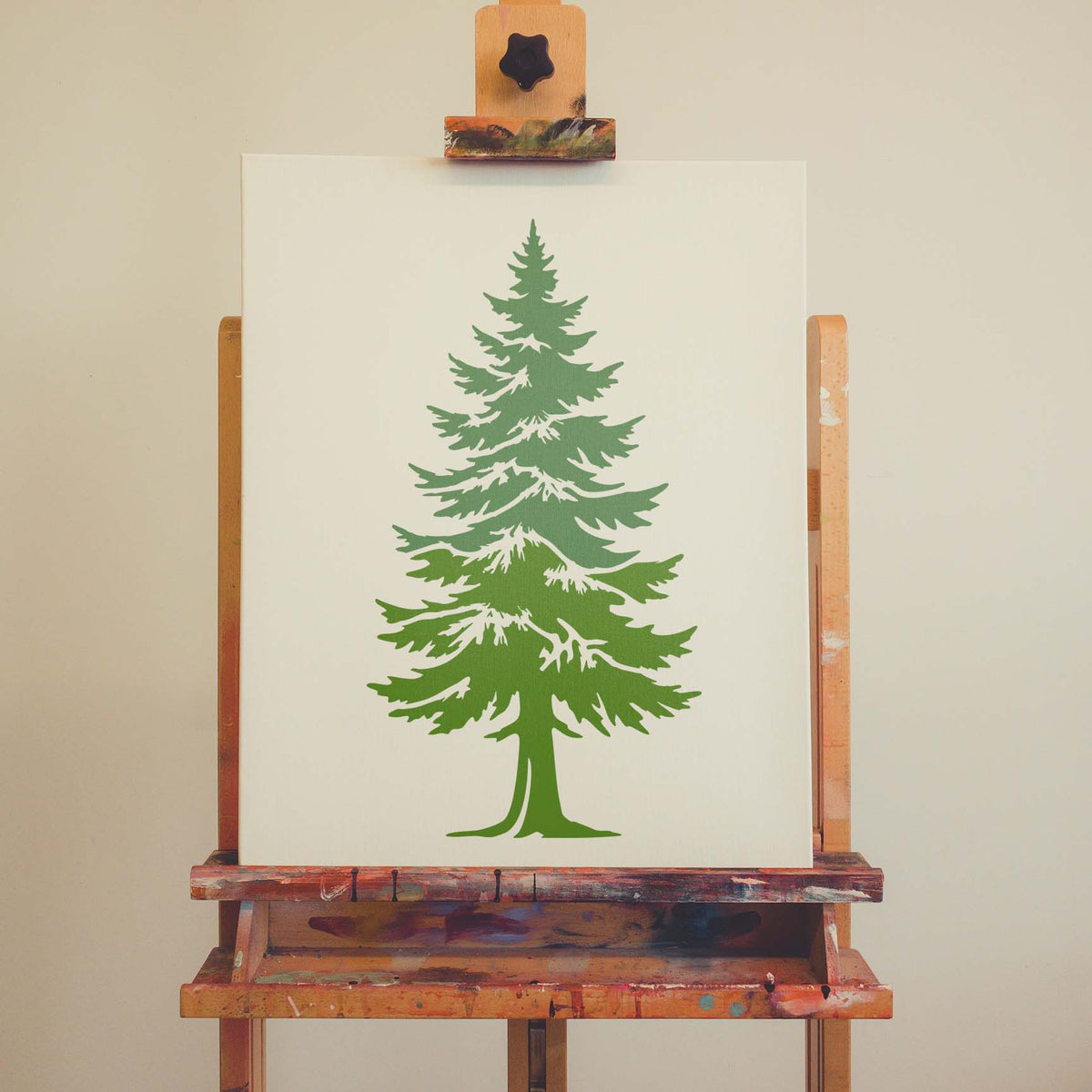 Detailed green pine tree stencil displayed on a clean artist canvas