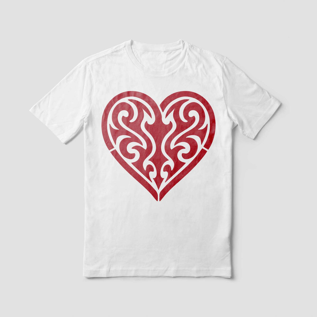 A white T-shirt displays the Tribal Heart Stencil in red with bold symmetrical swirls