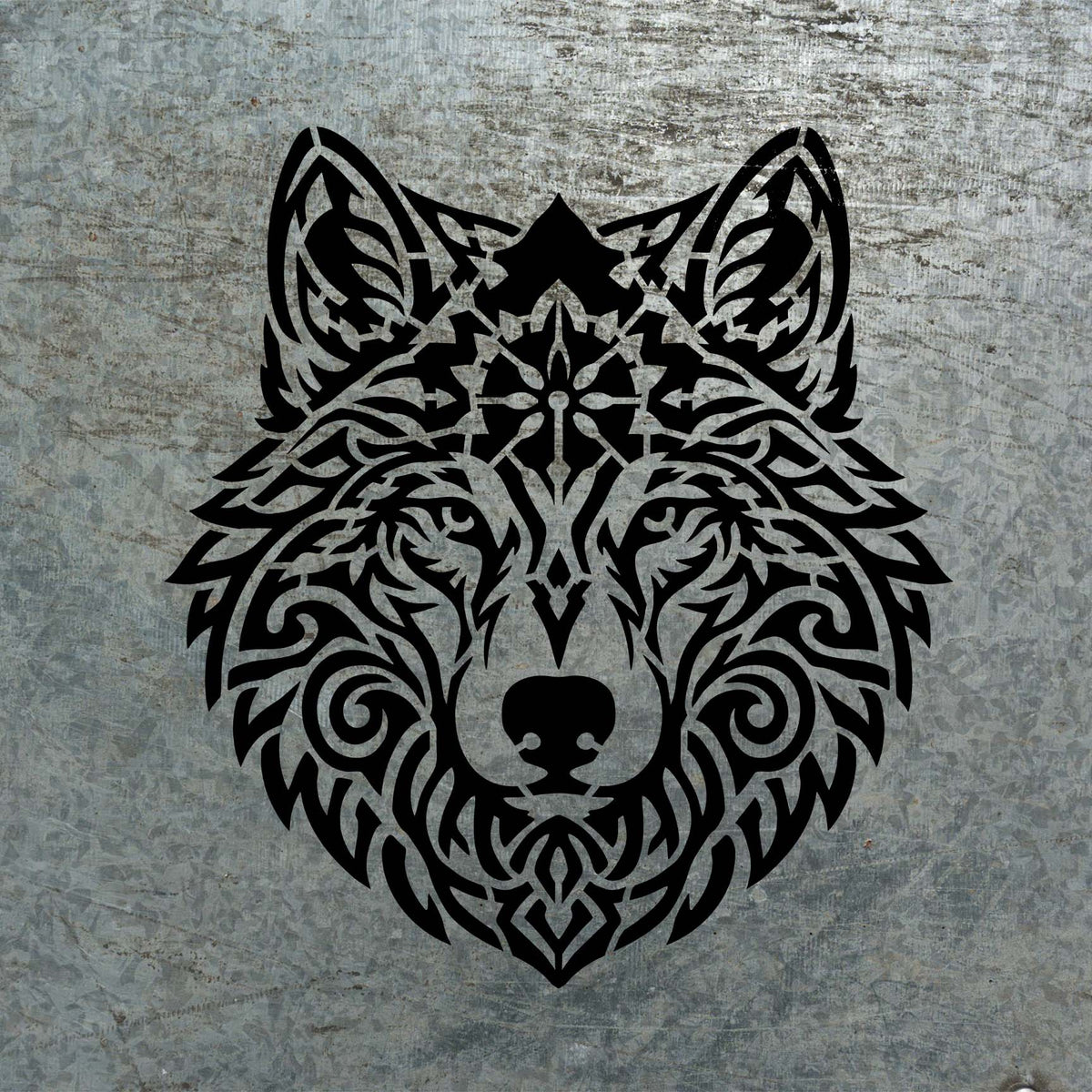 Intricate swirls and geometric details shape the Tribal Mandala Wolf Head Stencil on weathered metal.