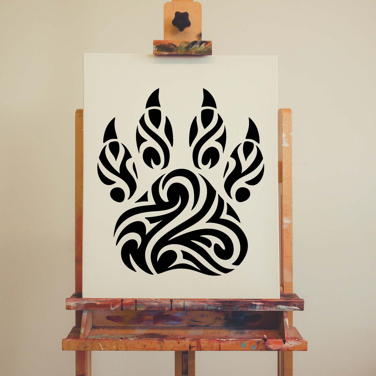 Tribal Paw Print Stencil with flowing black patterns displayed on canvas