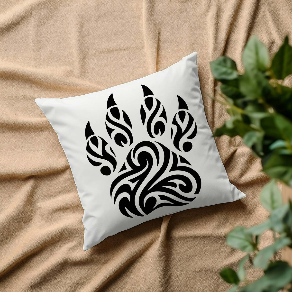 Tribal Paw Print Stencil with bold swirling design displayed on a white pillow