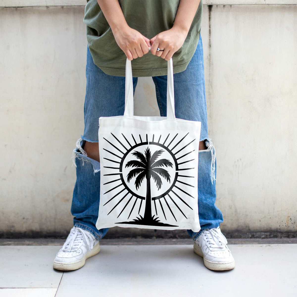 Tropical Palm Tree Sunburst Stencil printed boldly on a white canvas tote bag
