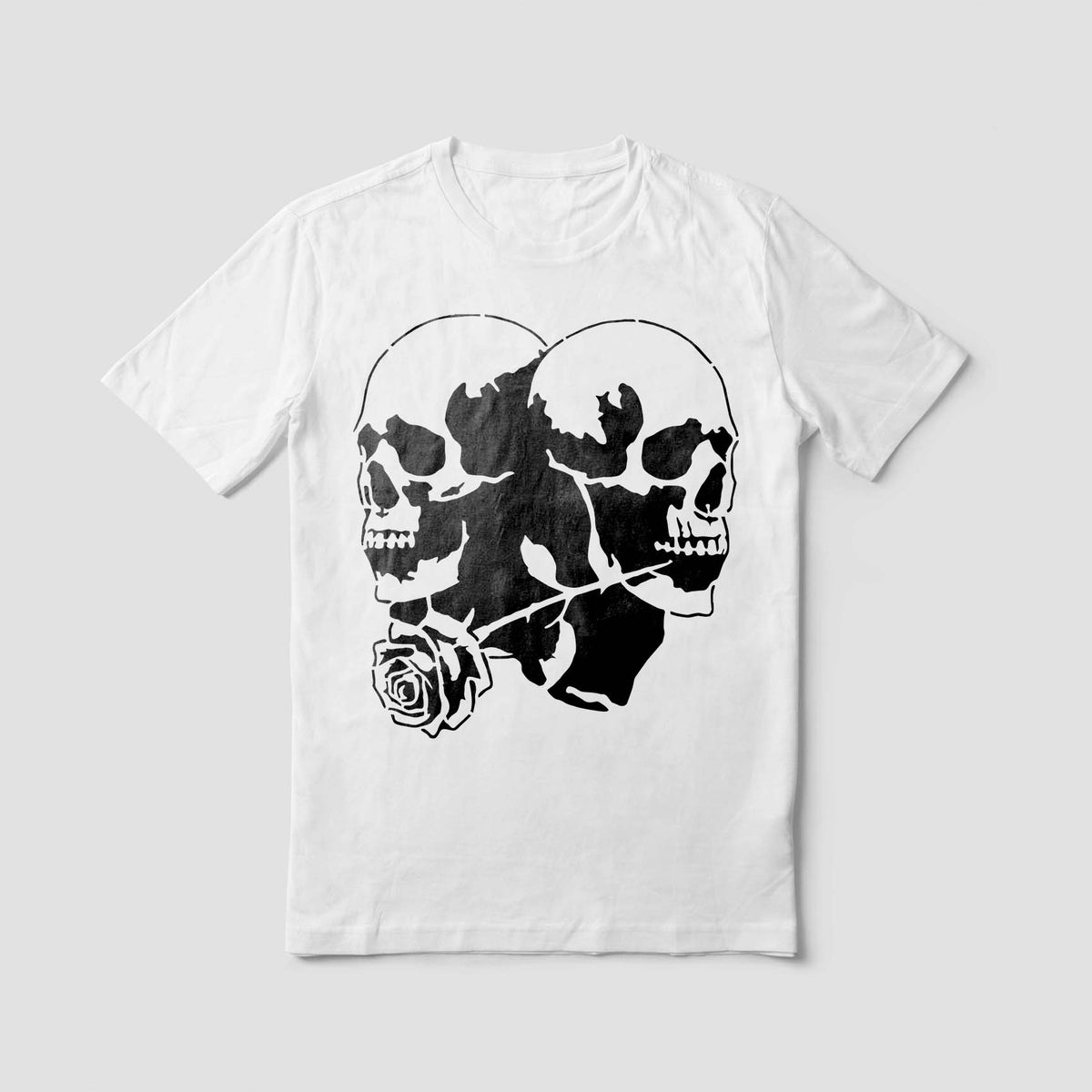 Bold Twin Skull Rose Stencil artwork pairs two mirrored skulls and a rose on a crisp white shirt