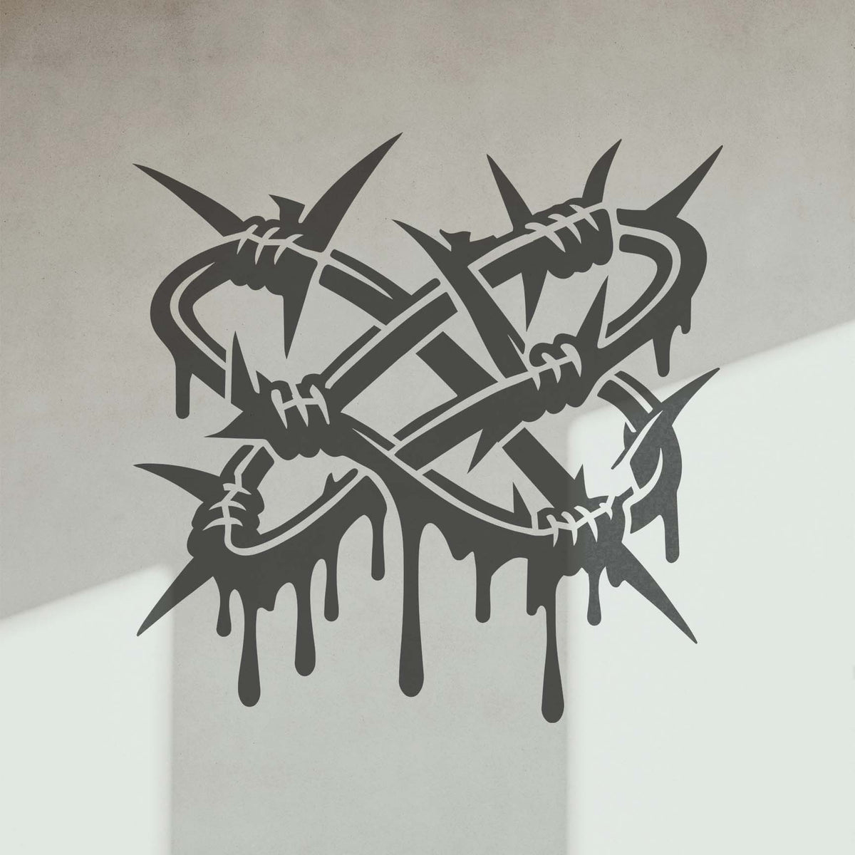 Interlocking barbs and flowing paint drips define the Twisted Barbed Wire Stencil on a white wall.