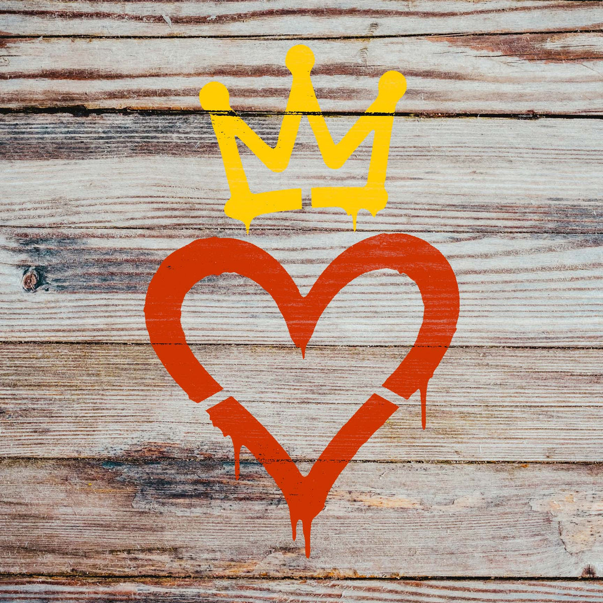 Urban Crown Heart Stencil stands out in orange and yellow across rustic weathered wood planks