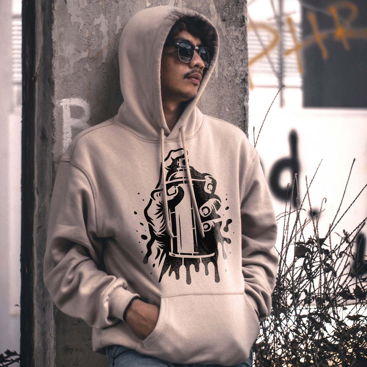 Street style hoodie featuring the Urban Spray Paint Can Stencil in black on a beige sweatshirt.
