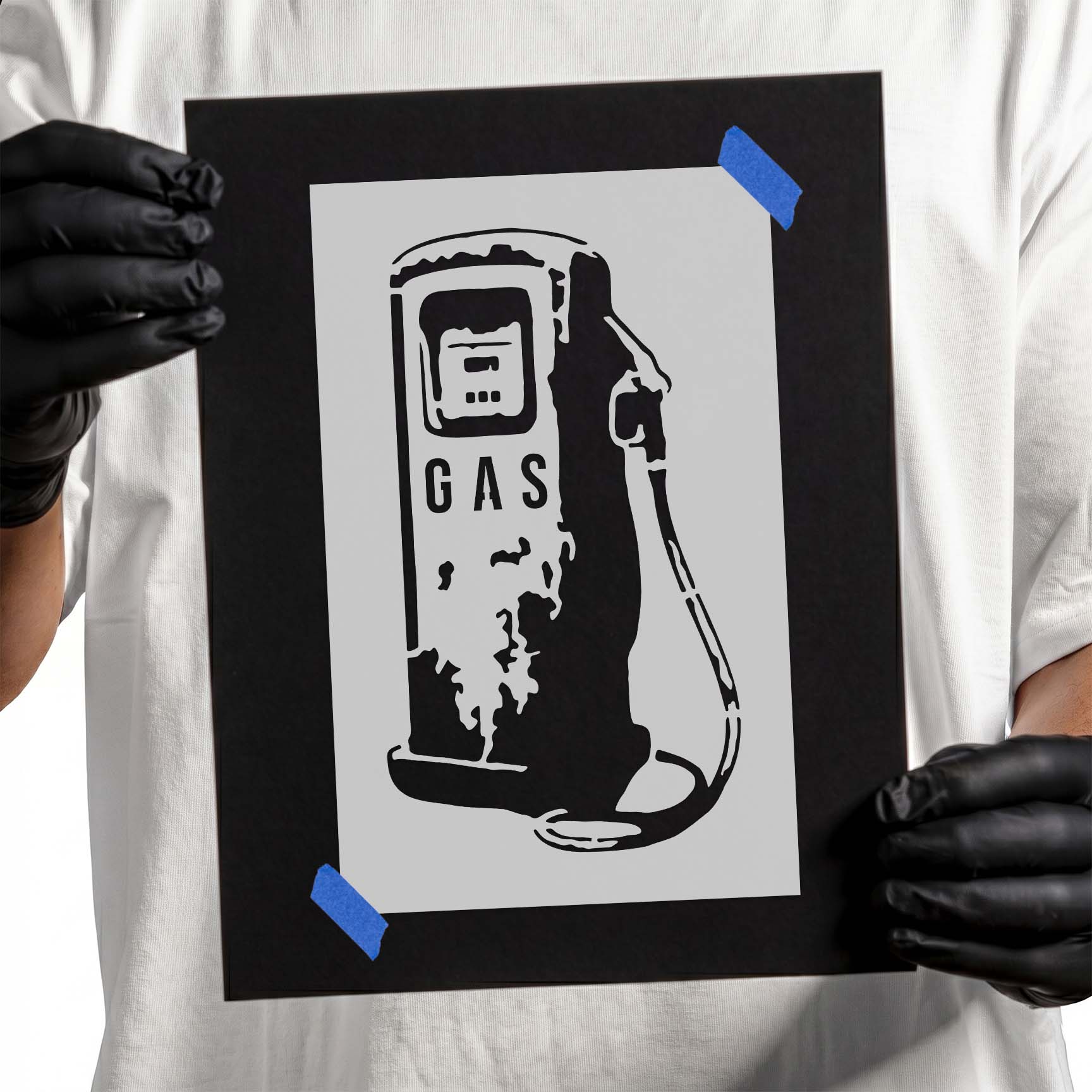 Person holding Vintage Gas Pump Stencil taped to black cardboard