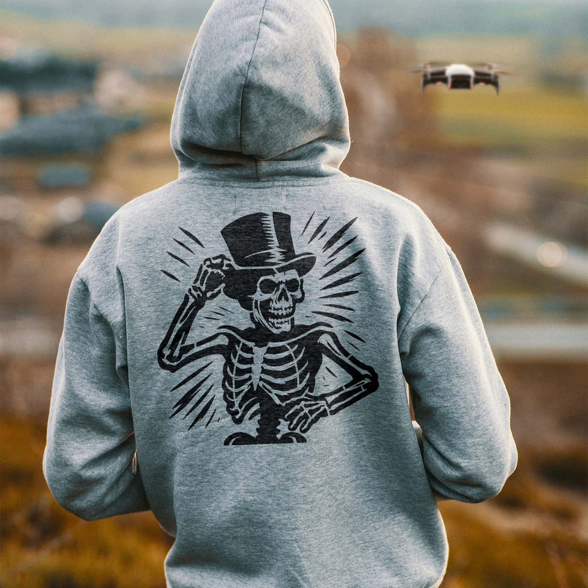 Vintage Top Hat Skeleton Stencil adds a dapper black skeleton design to a gray hoodie