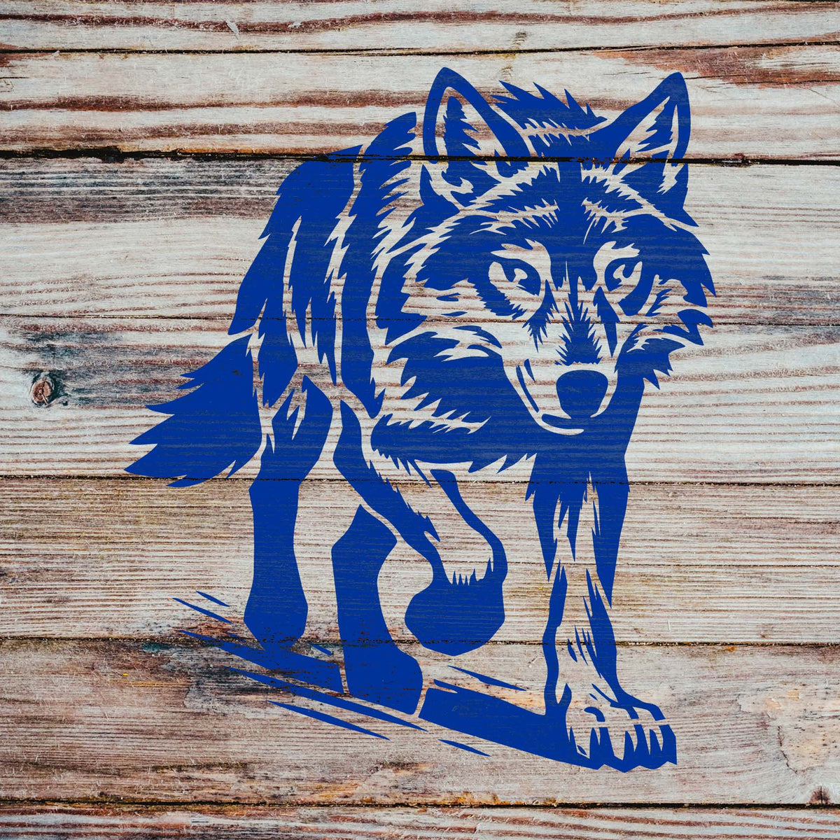 Rustic wood planks feature the Walking Wolf Stencil in blue, highlighting its detailed wild wolf form.