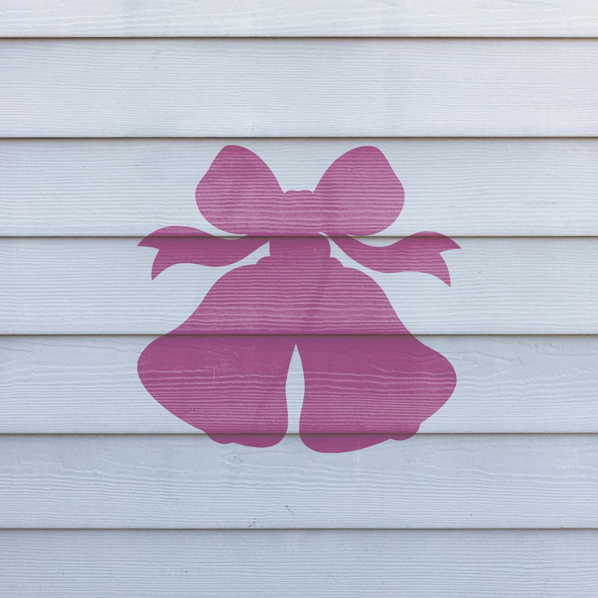 Wedding Bells stencil with ribbon bow painted on white siding wall
