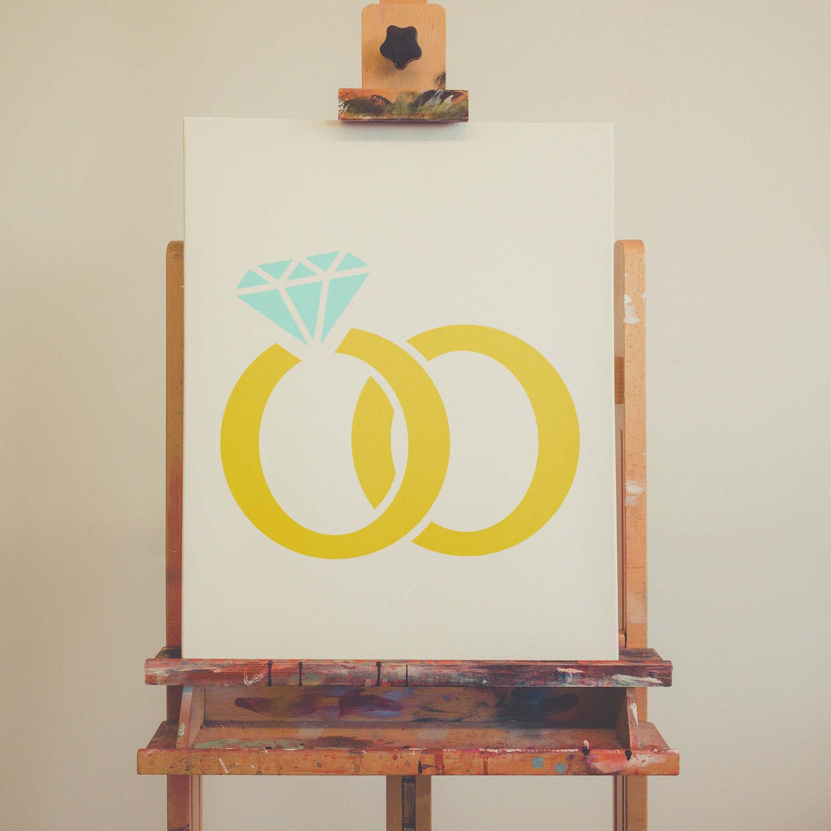 Interlocking Wedding Rings stencil with gold bands and blue diamond on canvas
